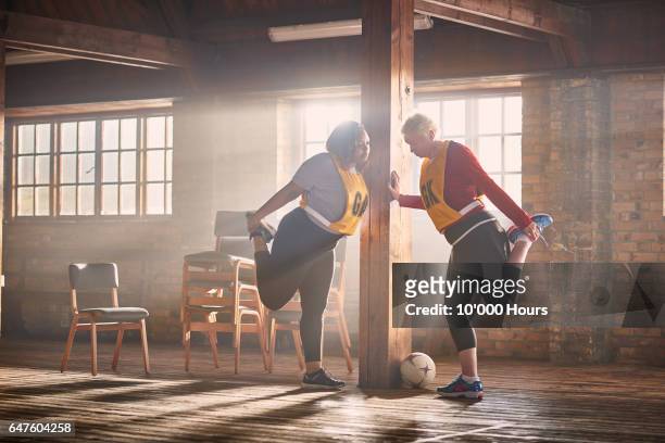 two women stretching in gym. - ball chair foto e immagini stock