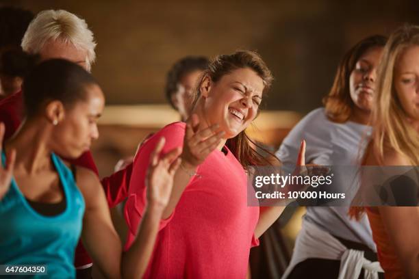 smiling women dancing in gym. - only women gym stock pictures, royalty-free photos & images