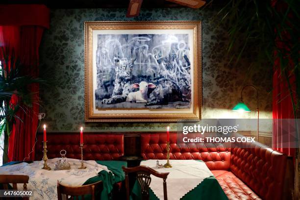 Banksy installation hangs above the booths in the lobby at street artist Banksy's newly opened Walled Off hotel in the Israeli occupied West Bank...