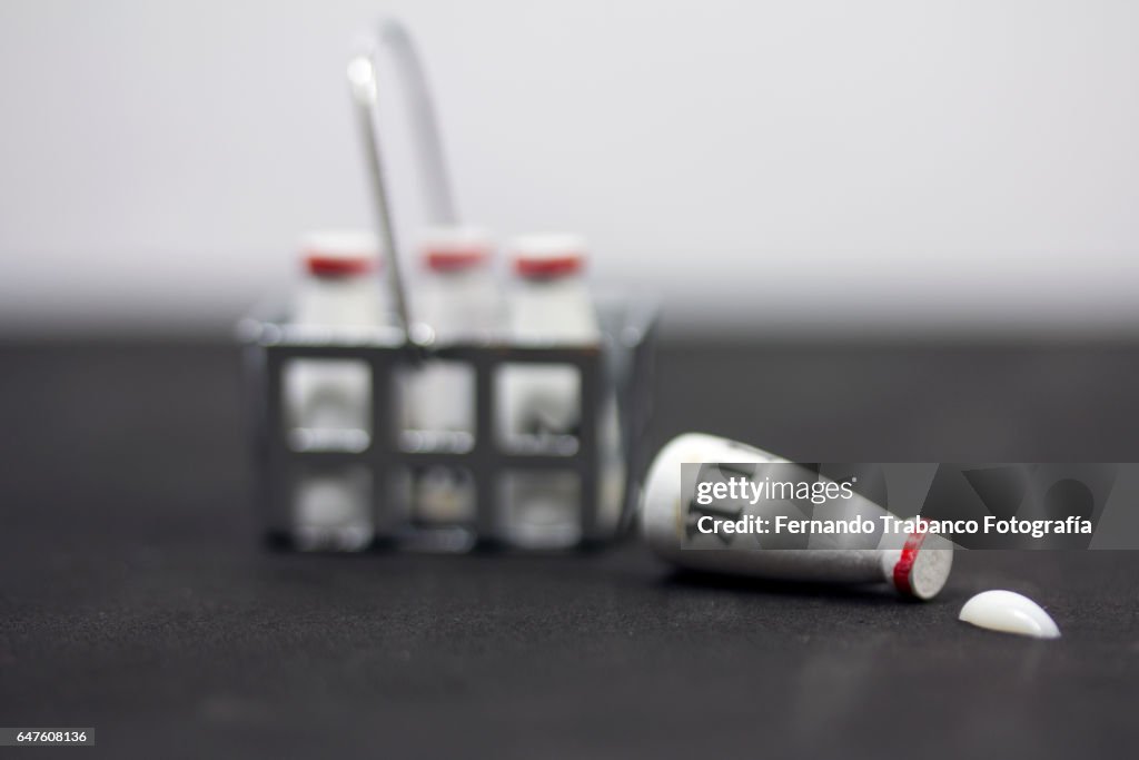 Cart with bottles of milk and a bottle spilled on the floor