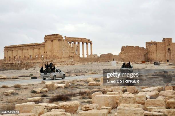 Picture taken on March 3, 2017 shows Syrian government forces driving up a road in the ancient city of Plamyra in central Syria. Syrian troops backed...