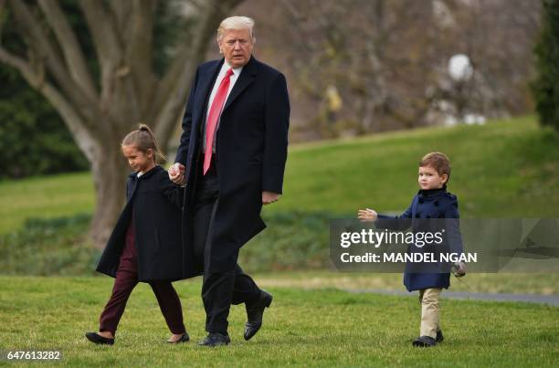 President Donald Trump makes his way to board Marine One with grandchildren Arabella Kushner and Joseph Kushner, from the White House in Washington,...