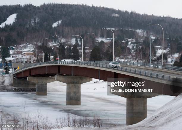 Car crosses over the International Bridge at the US/Canada border March 2 in Clair, New Brunswick. The truck is crossing from Caire to Fort Kent,...