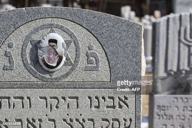Vandalized stones are scattered at Stone Road or Waad Hakolel Cemetery in Rochester, New York on March 3, 2017. - Vandals tumbled and defaced...