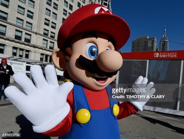 Mario from Super Mario Bros. Poses for pictures as the Nintendo Switch is unveiled at a pop-up Living room in Madison Square Park in New York on...