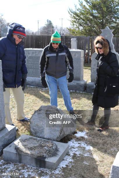 Richard Markus, Sidney Markus and Sandy Rosenthal look at a vandalized gravestone at Stone Road or Waad Hakolel Cemetery in Rochester, New York on...