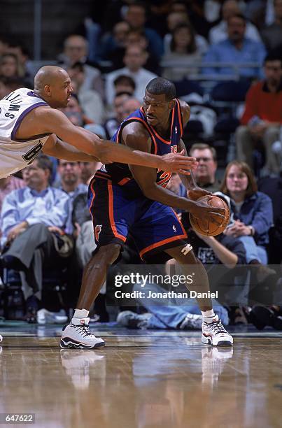 Larry Johnson of the New York Knicks guards the ball against Scott Williams of the Milwaukee Bucks during the game at the Bradley Center in...