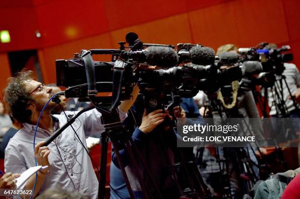 Journalists film during a press conference on the investigations relative to the missing of the four members of the Troadec Family, on March 3, 2017...