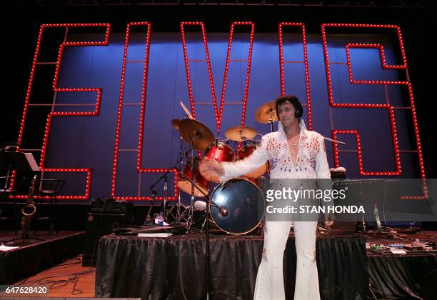 Shawn Klush of Franklin, Tennessee poses on stage after he was declared winner in The Ultimate Elvis Tribute Artist Contest, 17 August 2007, in...