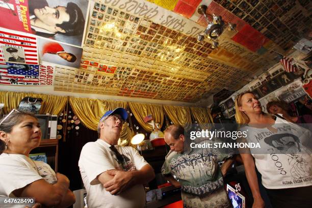 Visitors Toni Silva , Steve Schmitz , Fontaine Moore and Vicki Ellis get a tour of "Graceland Too", a vast collection of Elvis Presley related items,...