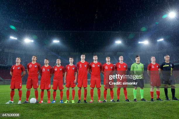 football team standing in a row - football team stock pictures, royalty-free photos & images