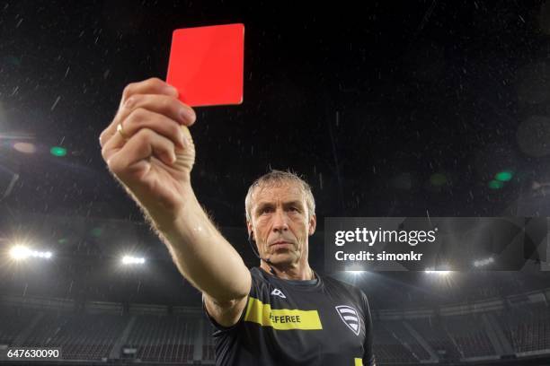 referee holds up red card - referee stock pictures, royalty-free photos & images