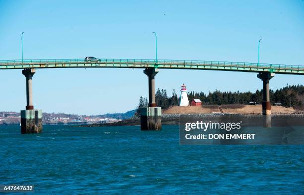 Cars cross the International Bridge between Lubec, Maine and Campobello Island, Canada March 3, 2017 in the US/Canada border town of Lubec, Maine....