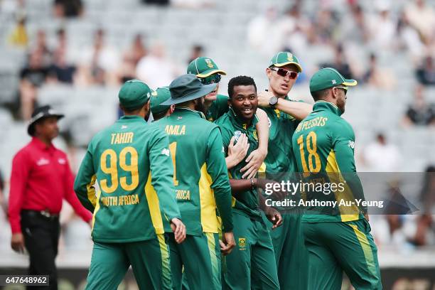 Andile Phehlukwayo of South Africa celebrates with teammates for the wicket of Dean Brownlie of New Zealand during game five of the One Day...