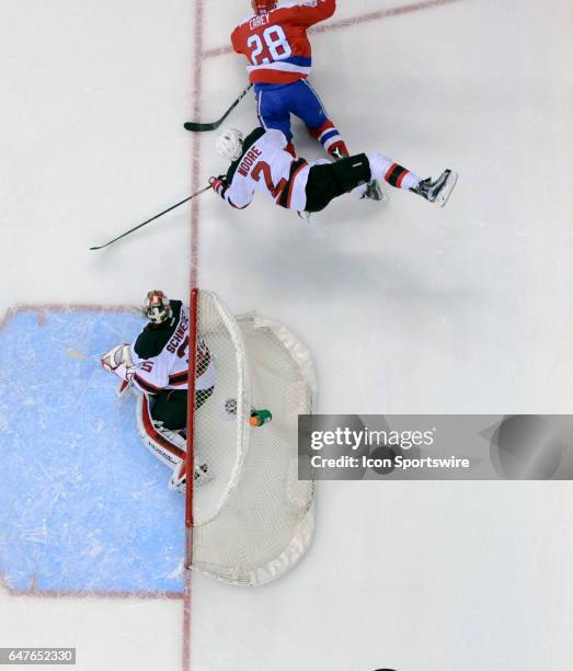 New Jersey Devils defenseman John Moore collides and is upended by Washington Capitals center Paul Carey in the first period on March 2 at the...