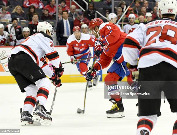 Washington Capitals left wing Alex Ovechkin shoots the puck in the first period against New Jersey Devils defenseman John Moore on March 2 at the...