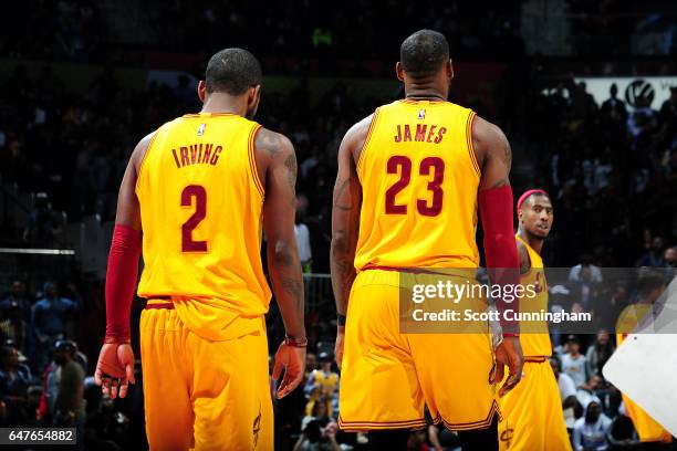 Kyrie Irving and LeBron James of the Cleveland Cavaliers looks on during the game against the Atlanta Hawks on March 3, 2017 at Philips Arena in...