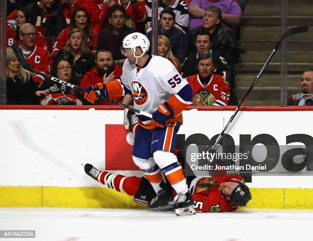 Brian Campbell of the Chicago Blackhawks hits the ice after colliding with Johnny Boychuk of the New York Islanders at the United Center on March 3,...