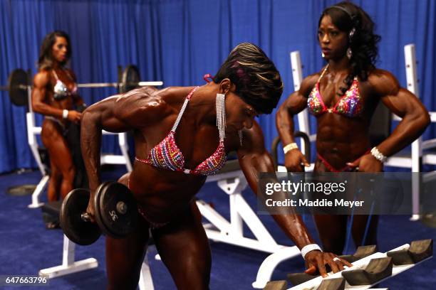 Women's Physique International contestants warm up in the pump up room backstage at the Greater Columbus Convention Center during the Arnold Sports...