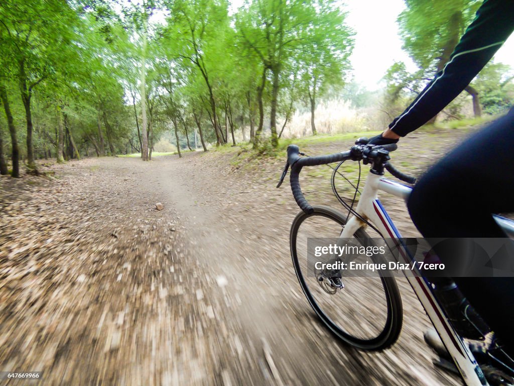 Single Track Riding A Cyclist Riding Along A Single Track In A Natural Park High-Res Stock ...