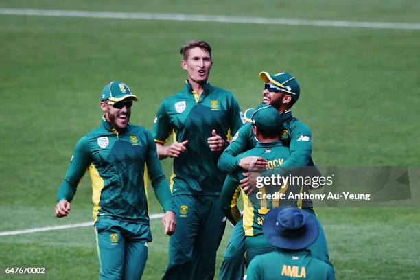 Duminy of South Africa celebrates with teammates for the wicket of Mitchell Santner of New Zealand during game five of the One Day International...