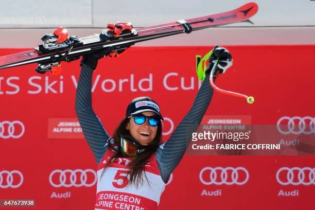Italy's Sofia Goggia reacts on the podium after winning the women's downhill race at the FIS Alpine Ski World Cup in Jeongseon, some 150km east of...