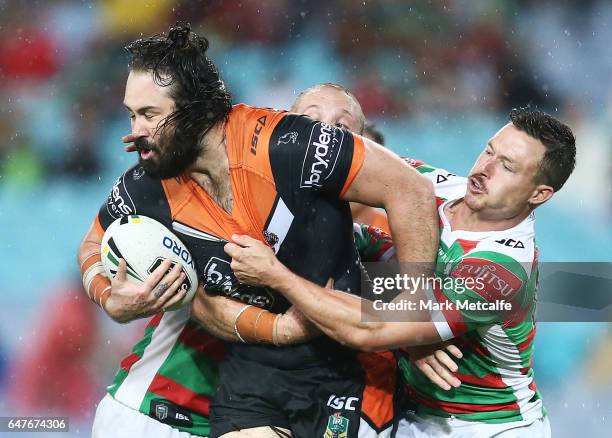 Aaron Woods of the Tigers is tackled during the round one NRL match between the South Sydney Rabbitohs and the Wests Tigers at ANZ Stadium on March...