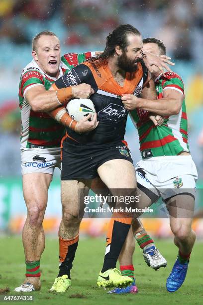 Aaron Woods of the Tigers is tackled during the round one NRL match between the South Sydney Rabbitohs and the Wests Tigers at ANZ Stadium on March...