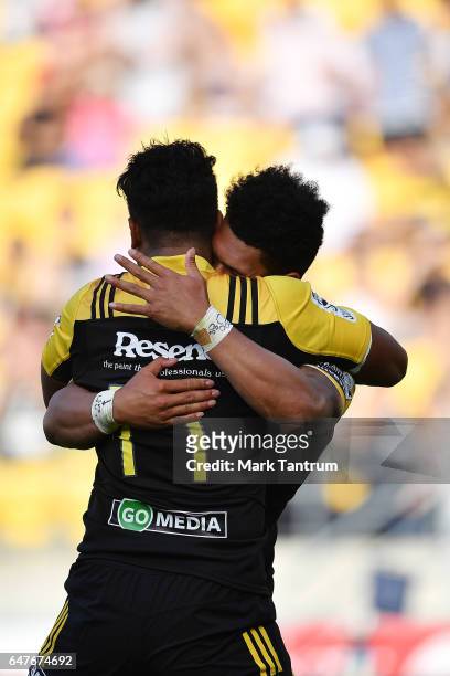 Julian Savea of the Hurricanes congratulates Ardie Savea of the Hurricanes during the round two Super Rugby match between the Hurricanes and the...