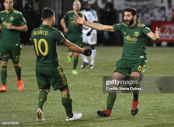 Diego Valeri celebrates with Sebastian Blanco of Portland Timbers after scoring a goal during the second half of the match against the Minnesota...