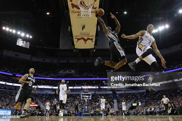 Jonathon Simmons of the San Antonio Spurs misses a shot as Tim Frazier of the New Orleans Pelicans defends during the first half of a game at the...