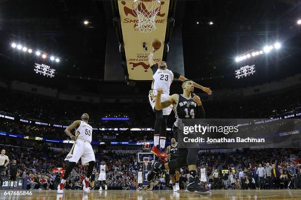 Anthony Davis of the New Orleans Pelicans dunks the ball against Danny Green of the San Antonio Spurs during the second half of a game at the...