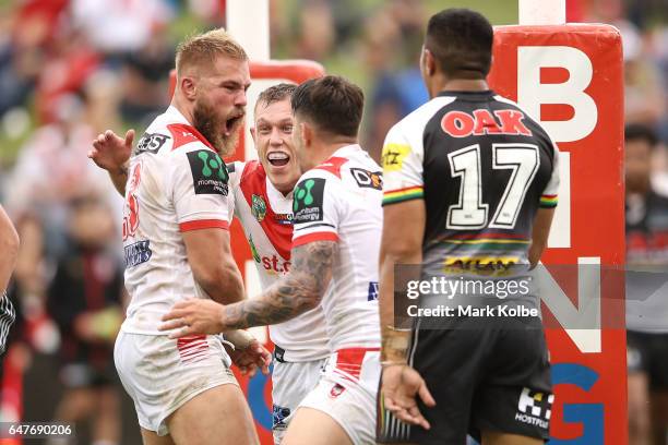 Jack de Belin of the Dragons celebrates with his team mates after scoring a try during the round one NRL match between the St George Illawarra...