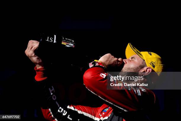 Race winner Shane Van Gisbergen driver of the Red Bull Holden Racing Team Holden Commodore VF celebrates on the podium after race 1 for the Clipsal...