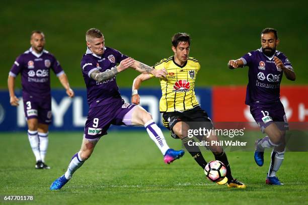 Alex Rodrigeuz of Wellington is tackled by Andrew Keogh of Perth during the round 22 A-League match between the Wellington Phoenix and the Perth...