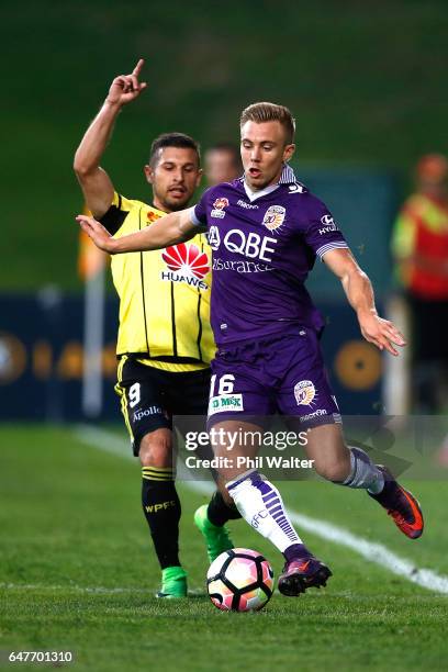 Joseph Mills of Perth is tackled by Kosta Barbarouses of Wellington during the round 22 A-League match between the Wellington Phoenix and the Perth...