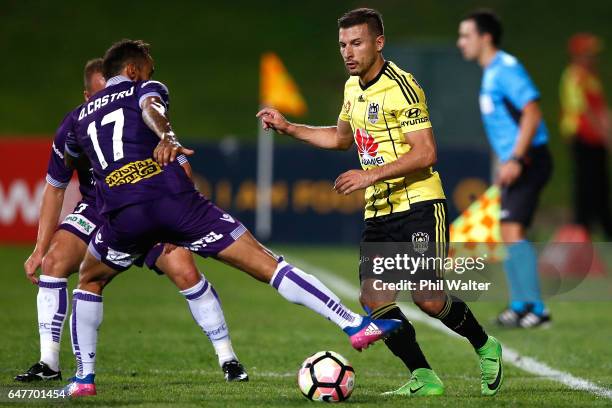 Kosta Barbarouses of Wellington is put under pressure from Diego Castro of Perth during the round 22 A-League match between the Wellington Phoenix...