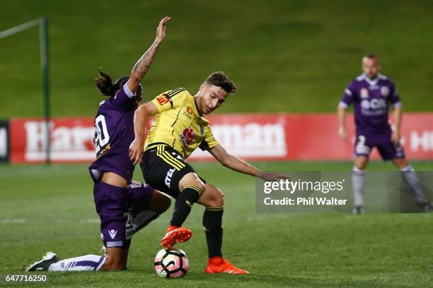 Matthew Ridenton of Wellington is tackled by Aryn Williams of Perth during the round 22 A-League match between the Wellington Phoenix and the Perth...