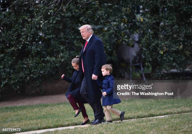President Donald Trump walks to Marine One on the South Lawn of The White House with his grandchildren Joseph and Arabella Kushner, before departing...