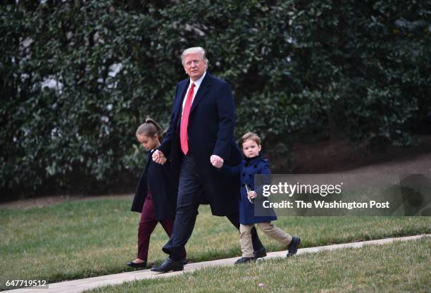 President Donald Trump walks to Marine One on the South Lawn of The White House with his grandchildren Joseph and Arabella Kushner, before departing...