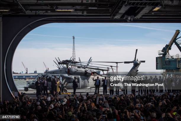 President Donald Trump rides an elevator to the flight deck after speaking aboard nuclear aircraft carrier Gerald R. Ford at Newport News...