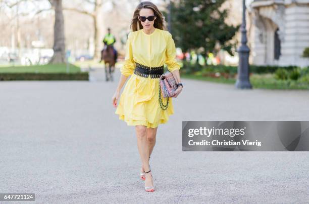 Alexandra Lapp wearing yellow banana dress Marc Cain, loose-fitting dress with flounce-like tiers, narrow, single-buttoned, Azzedine Alaia, Chiara...