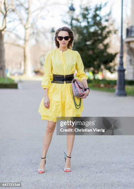 Alexandra Lapp wearing yellow banana dress Marc Cain, loose-fitting dress with flounce-like tiers, narrow, single-buttoned, Azzedine Alaia, Chiara...