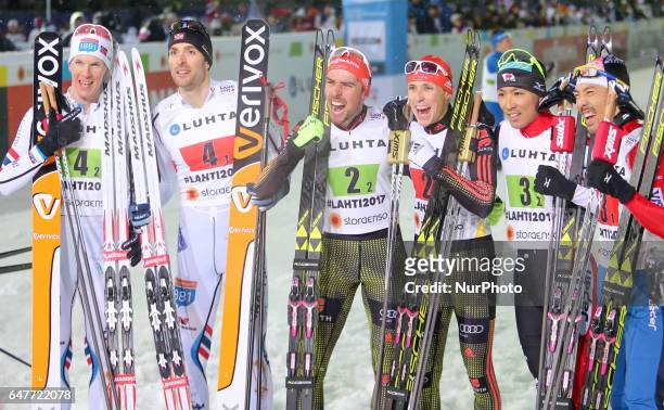 Johannes Rydzek and Eric Frenzel of Germany celebrate winning the gold medal with silver medallists Magnus Krog and Magnus Hovdal Moan of Norway and...