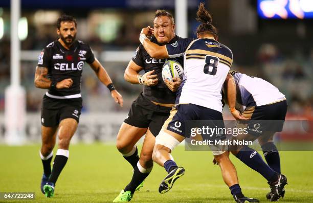 Coenie Oosthuizen of the Sharks is tackled during the round two Super Rugby match between the Brumbies and the Sharks at GIO Stadium on March 4, 2017...