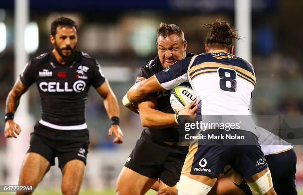 Coenie Oosthuizen of the Sharks is tackled during the round two Super Rugby match between the Brumbies and the Sharks at GIO Stadium on March 4, 2017...