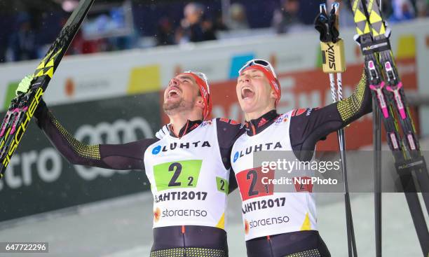 Johannes Rydzek and Eric Frenzel of Germany celebrate winning the gold medal in the Men's Nordic Combined HS130 Ski Jumping / 2 x 7.5km Team Sprint...