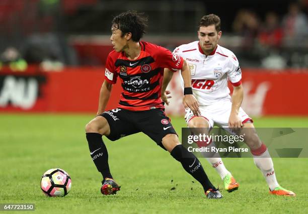 Jumpei Kusukami of the Wanderers competes for the ball against Ben Garuccio of Adelaide United during the round 22 A-League match between the Western...