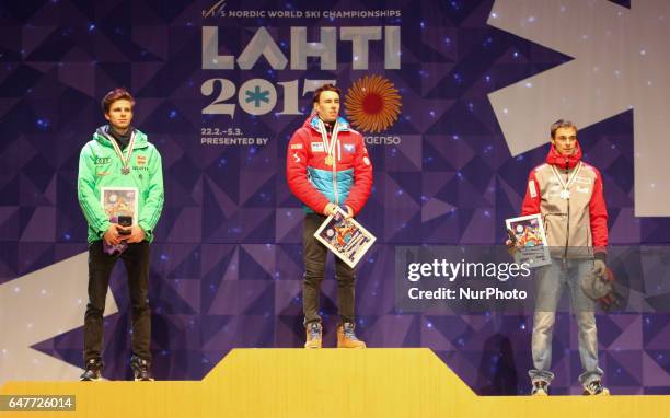 Silver medalist Andreas Wellinger of Germany, gold medalist Stefan Kraft of Austria and bronze medalist Piotr Zyla of Poland celebrate during the...