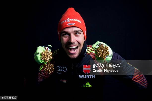 In this handout supplied by NordicFocus, Johannes Rydzek of Germany poses with the four gold medals he won during the FIS Nordic World Ski...